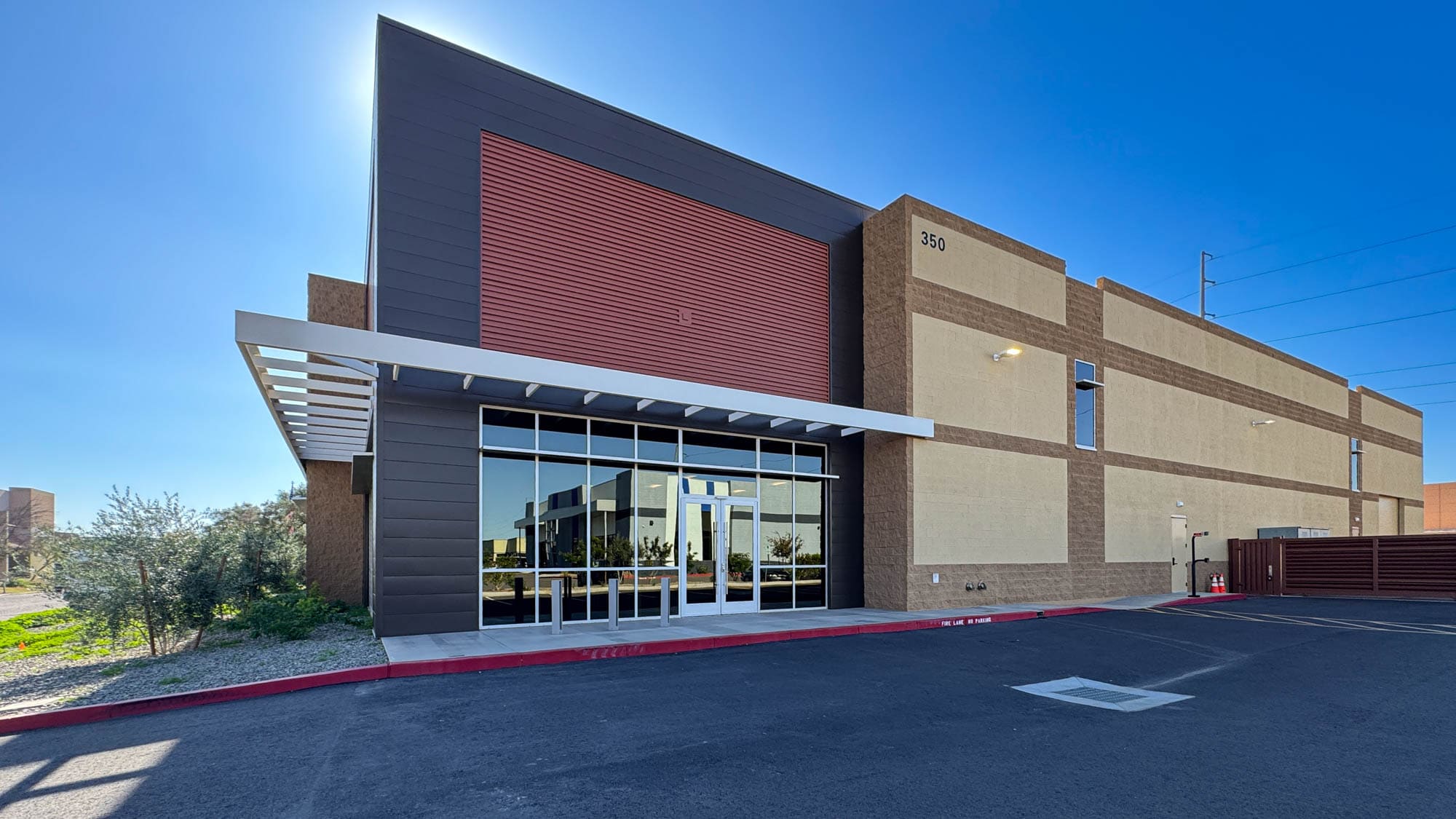 Modern commercial building with sleek design and large glass entry.