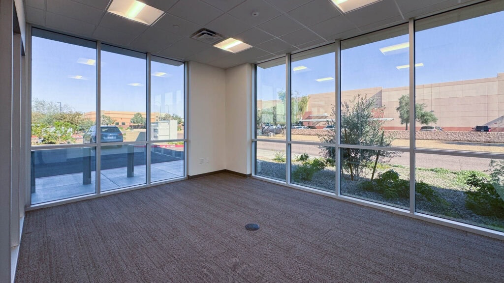 Bright office interior with floor-to-ceiling windows, perfect for commercial business environments.