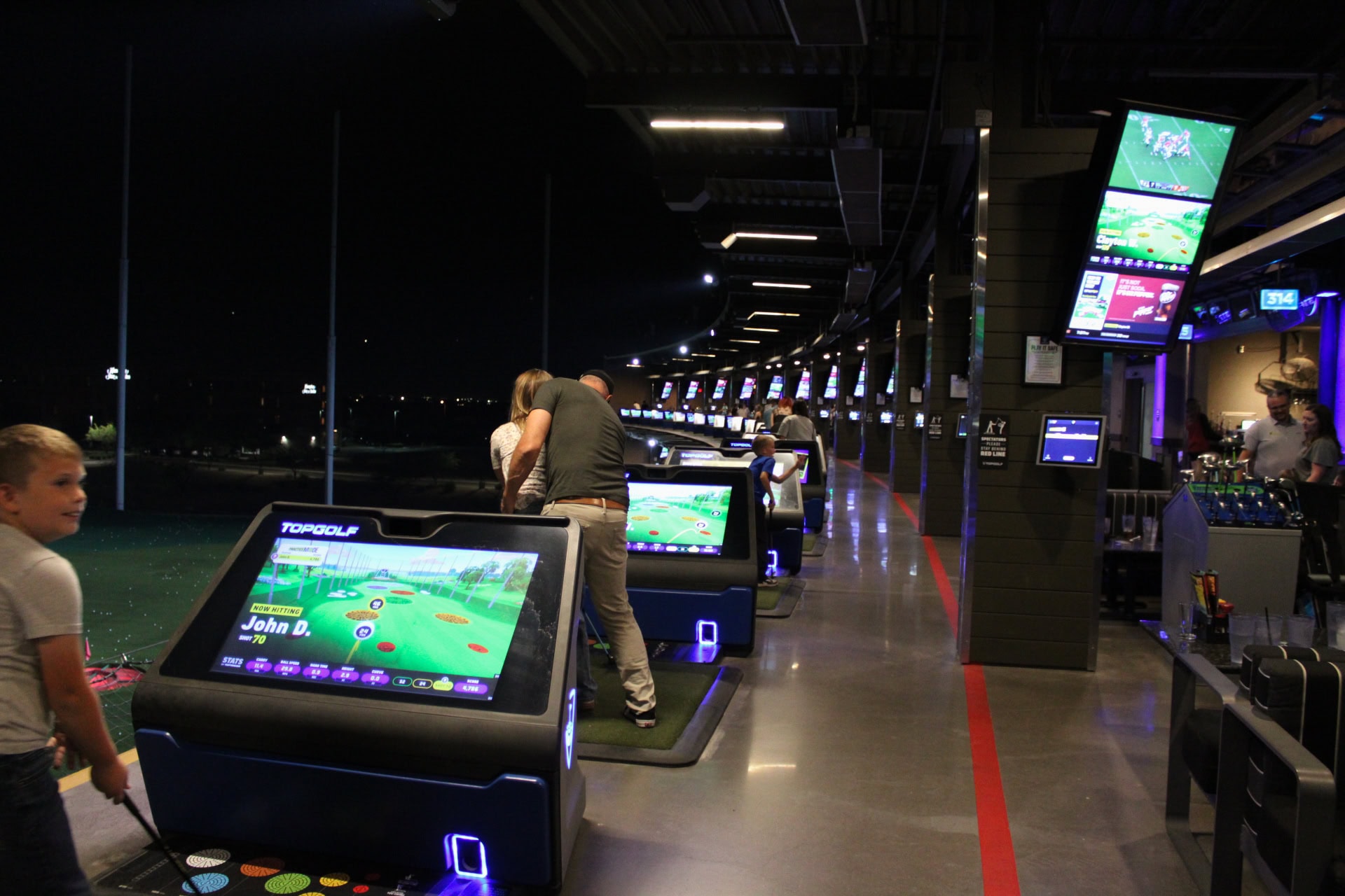 Topgolf Scottsdale night event hosted by TLW Construction with guests enjoying golf games and social.